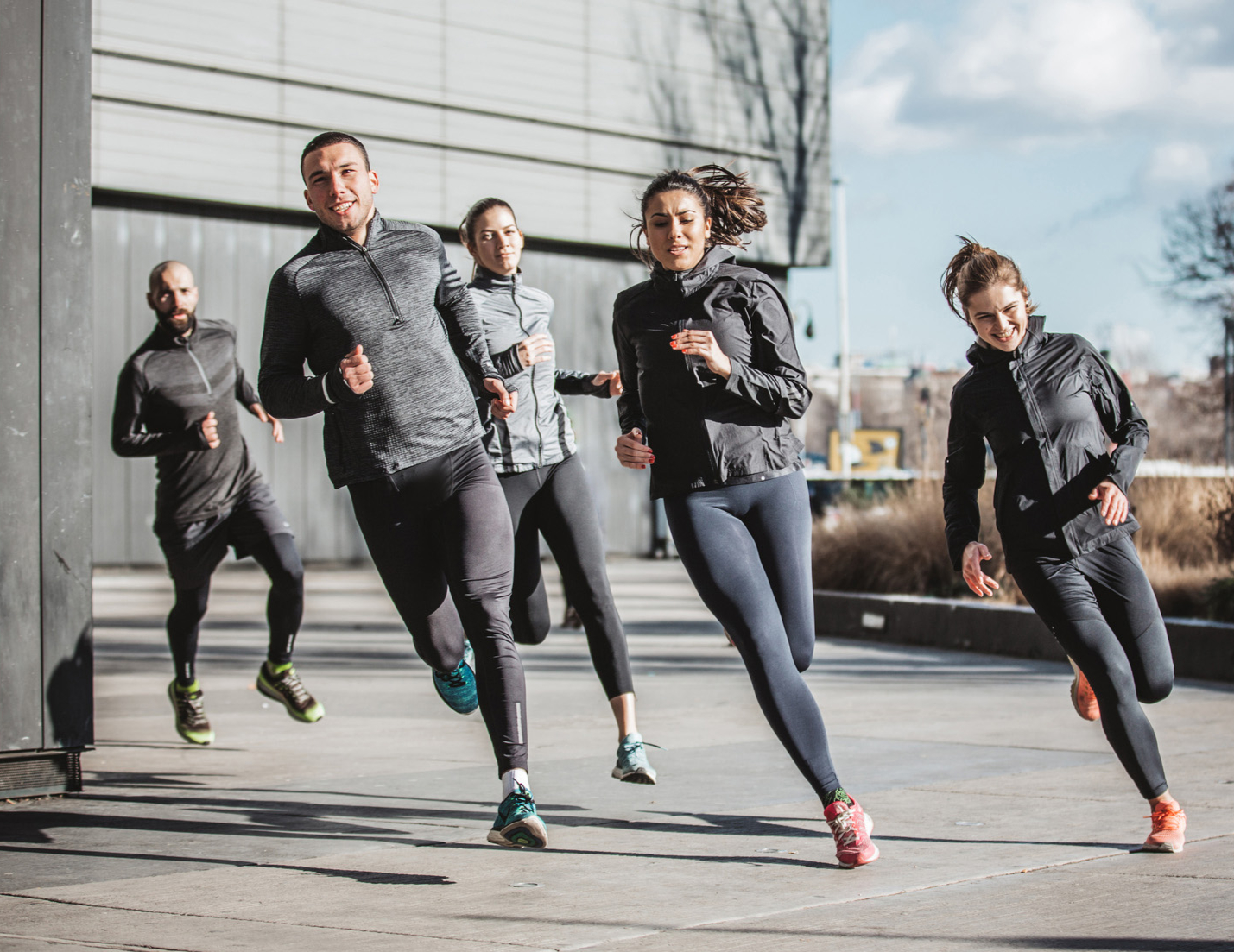 Group of men and women running
