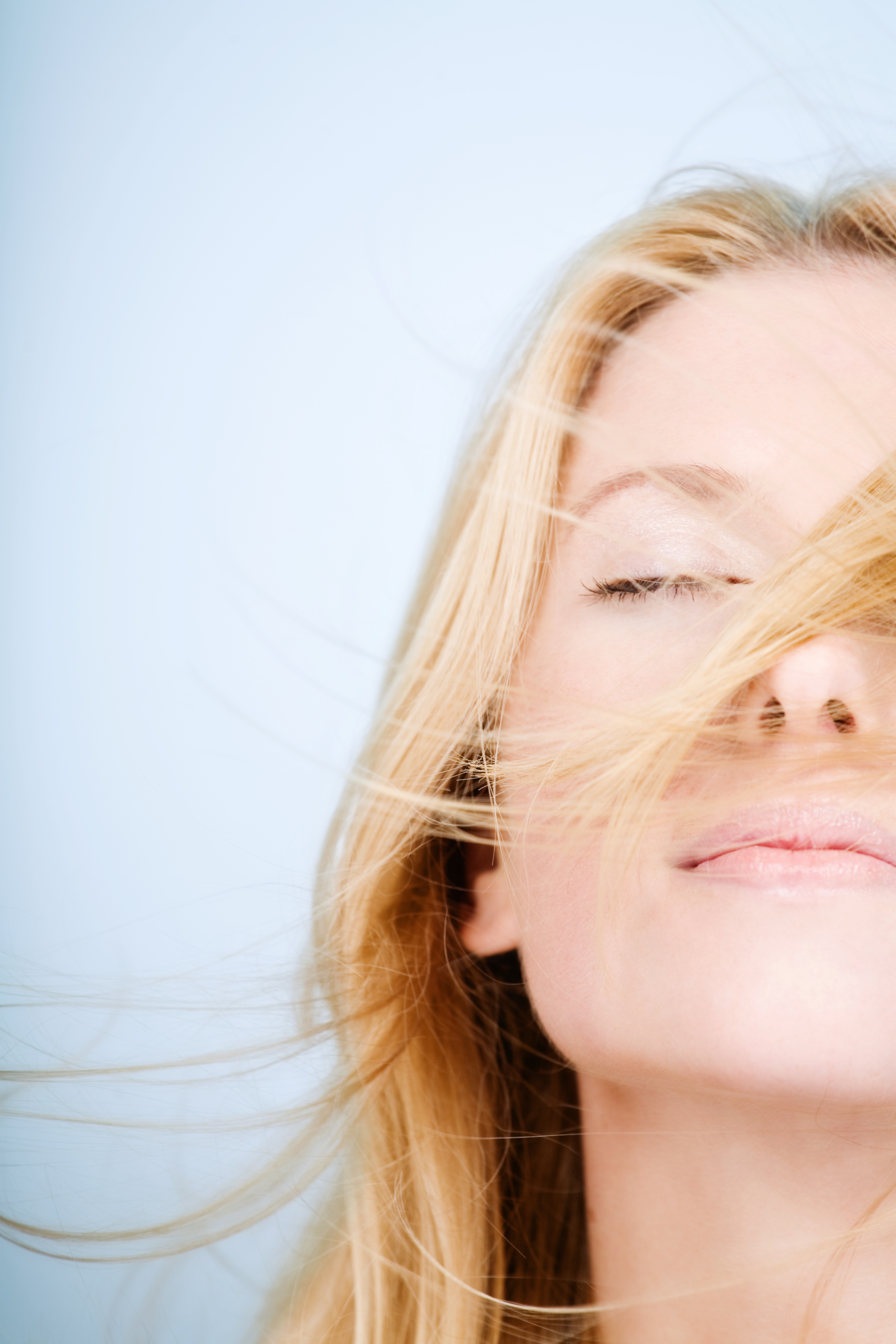 Cosmetic Injections 5 Content woman with her eyes closed in the breeze after cosmetic injections.