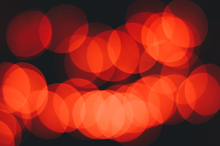 Out of focus red circle pattern, representing red light therapy