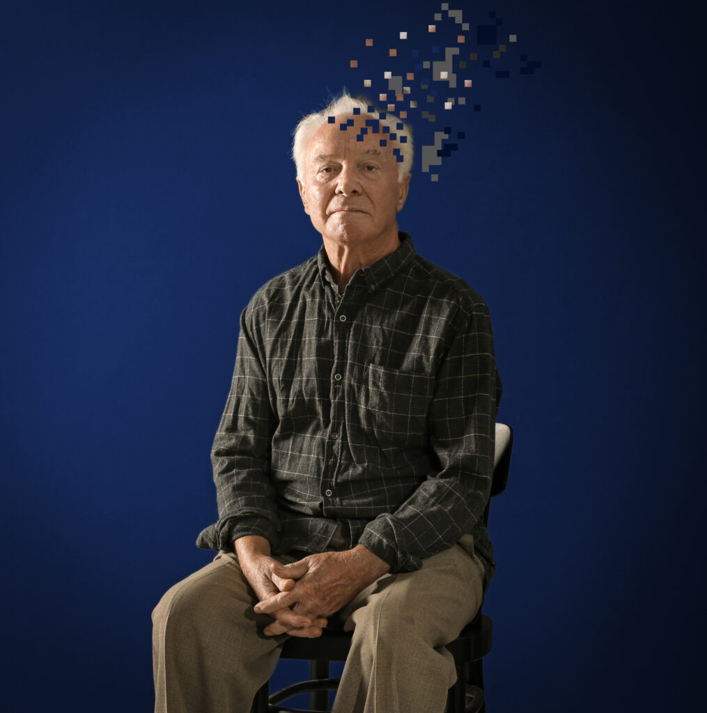 Lifespan Health Blog 4 Elderly man sitting, with illustration of head losing fragments, representing Therapeutic Plasma Exchange for Alzheimers