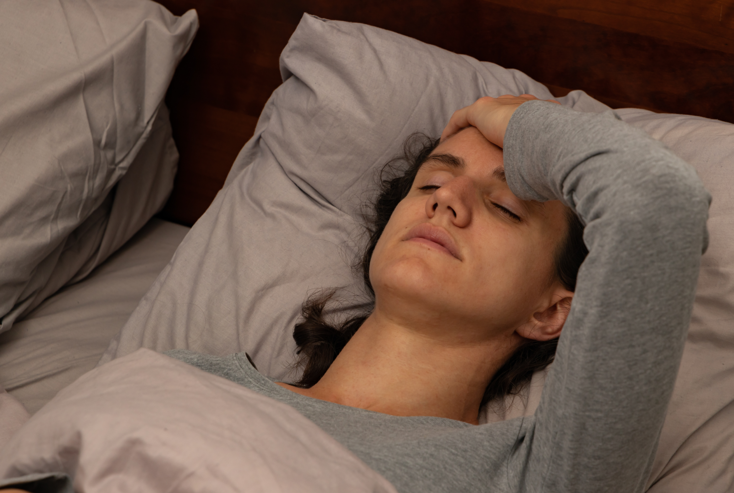 Woman with Long COVID lying in bed