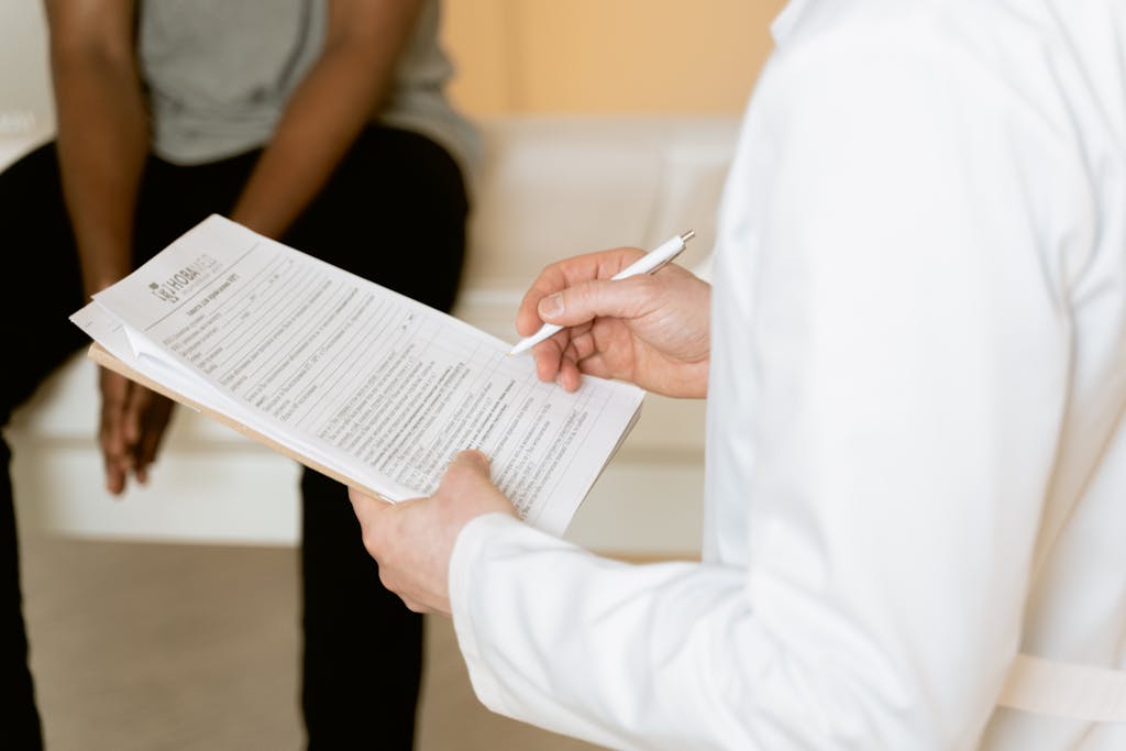 Mold Illness Treatment in Minneapolis | Lifespan Health 4 Healthcare professional reviews medical form during patient consultation in a clinic setting.