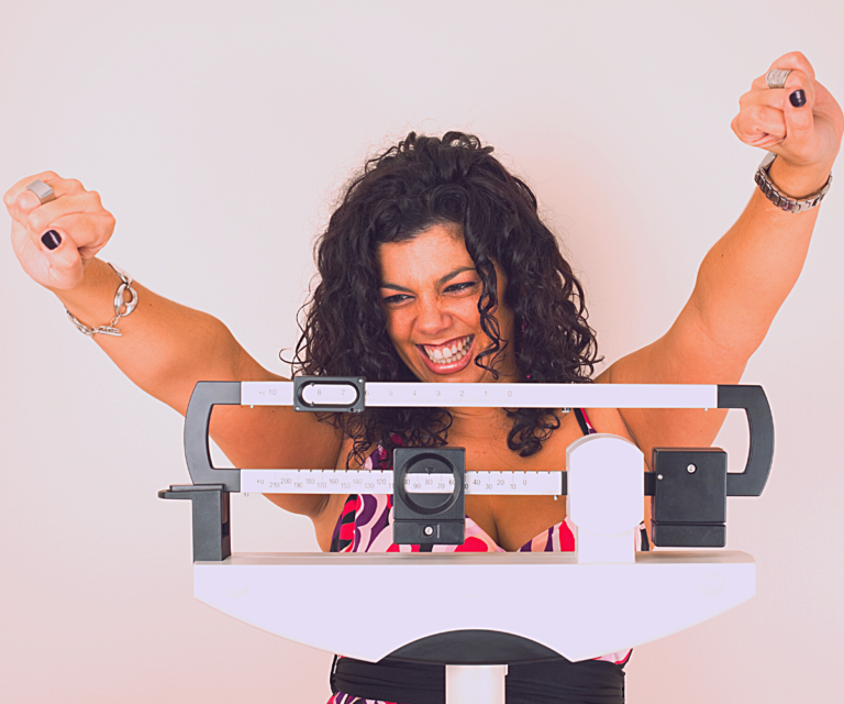 True Medical Weight Management 1 Happy woman on a scale, representing medical weight managment
